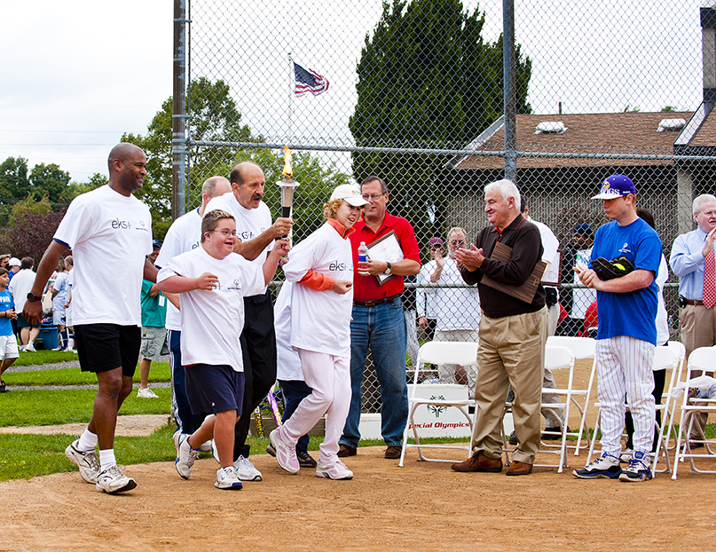 Tom GOlisano cheers on the Special OLympics athletes on the torch run